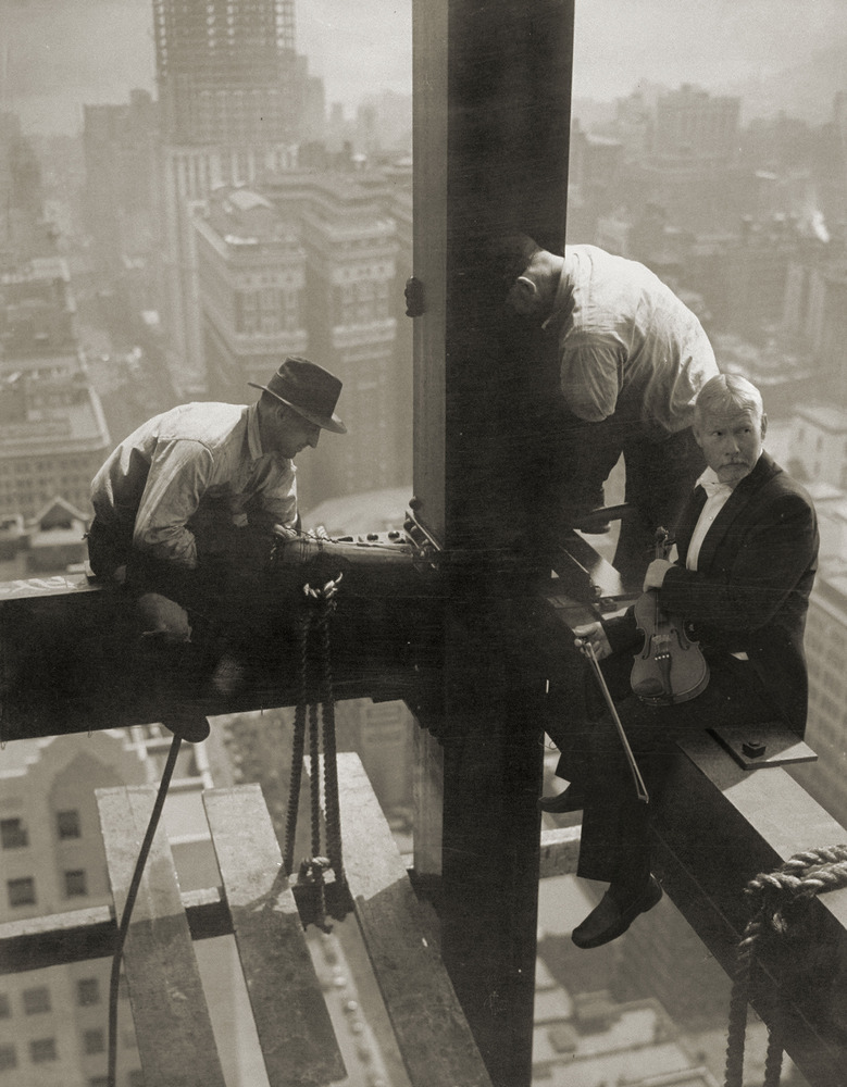 Workmen attaching steel beams high above